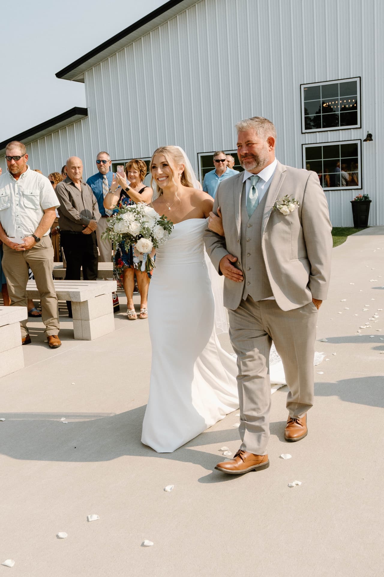 Austyn walking down the aisle with her dad at their Williamsburg, Iowa wedding