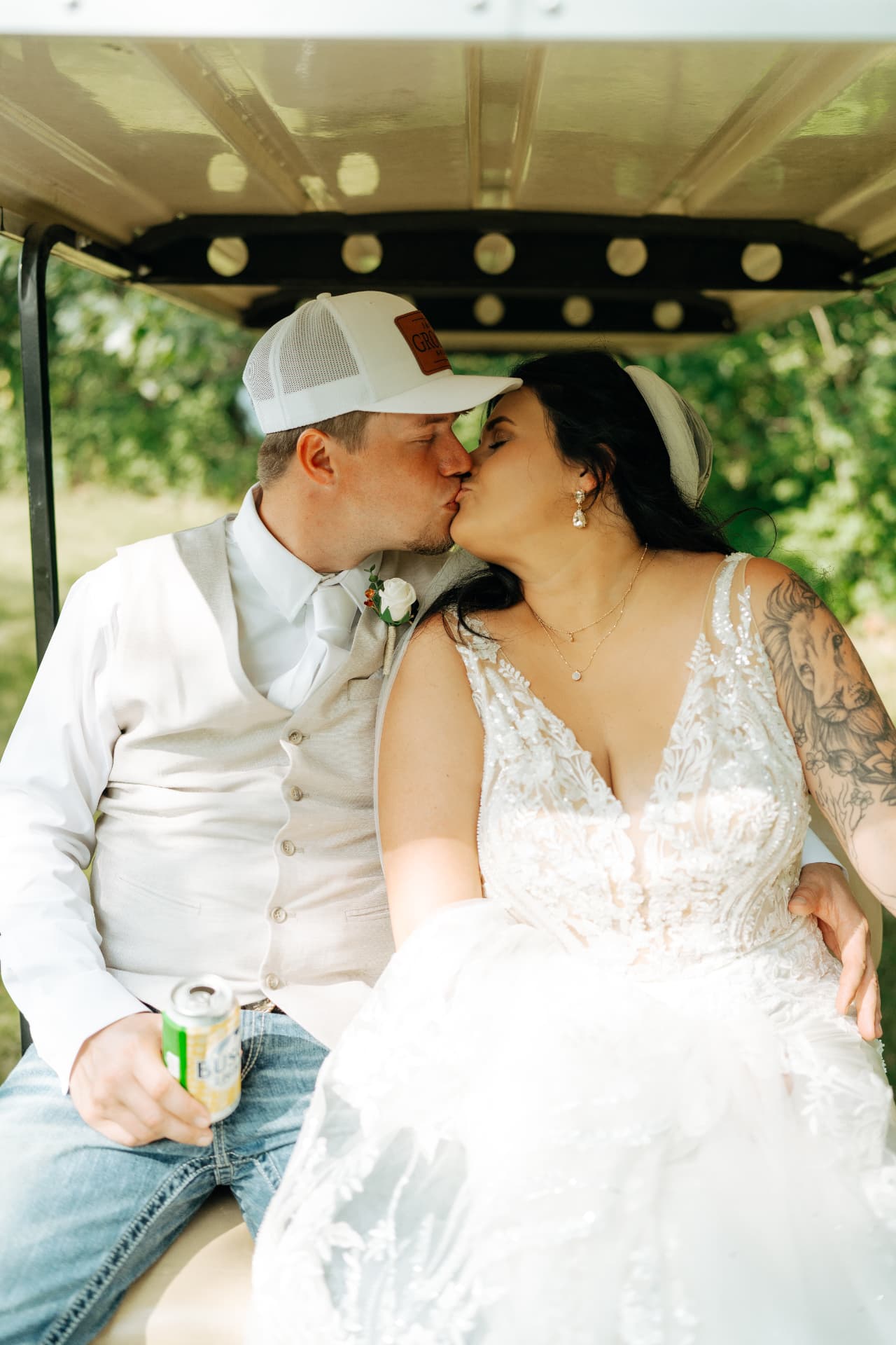 Morgyn and Jake kissing in a golf cart after their Ainsworth, Iowa backyard wedding